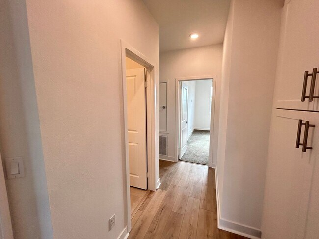 Building Photo - Gorgeous, 3 level townhome, featuring 2 car garage central Air, and in Unit laundry.