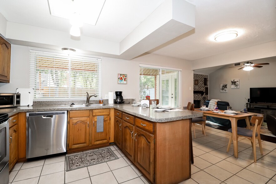 This view of the kitchen and dining area is from the laundry room entryway. - 2507 Holt Road