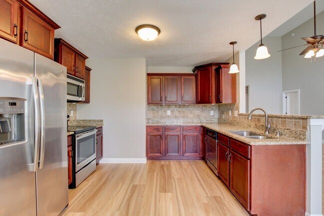 Building Photo - Fantastic Open Floor Plan Home With Stone Front Fireplace, Stainless Steel Appliances, And Close ...