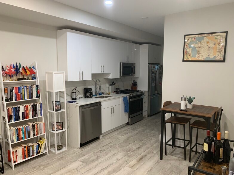 Kitchen with high top table and brand new appliances. - 2556 University Pl NW
