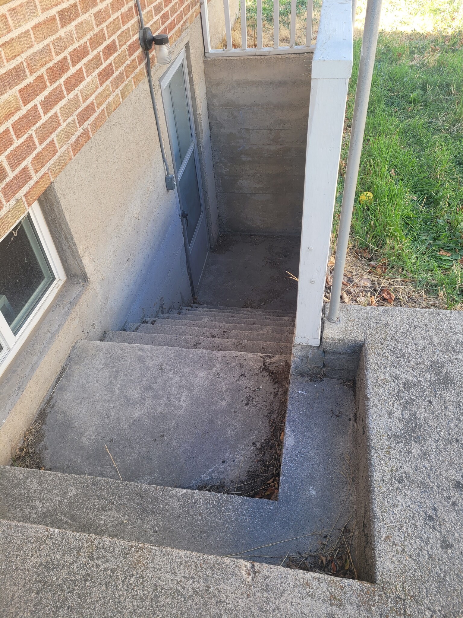 Stairs leading down to apartment entrance - 481 S 100 E