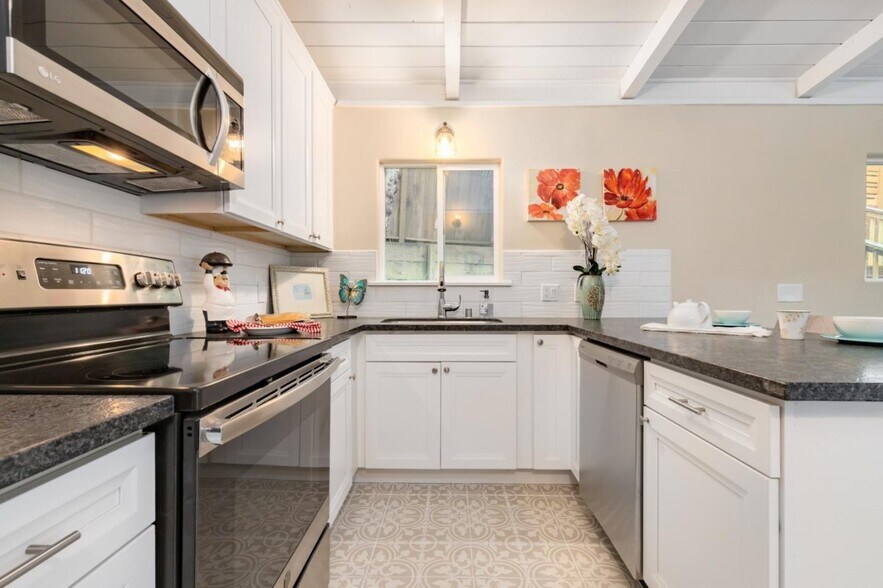 All new kitchen with stainless steel appliances, new cabinets and countertops, and new tile floor. - 665 Cathedral Dr