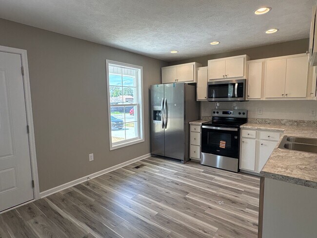 Building Photo - Charming New Home with a Rocking Chair Front Porch!