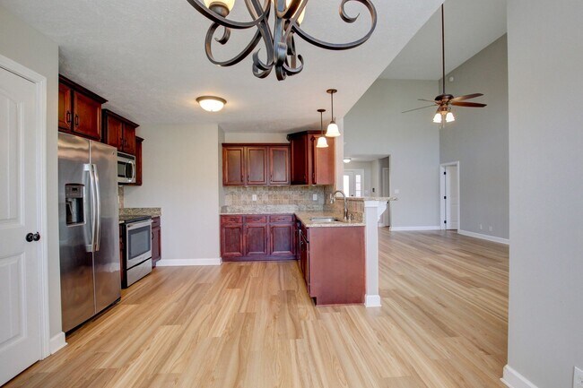 Building Photo - Fantastic Open Floor Plan Home With Stone Front Fireplace, Stainless Steel Appliances, And Close ...