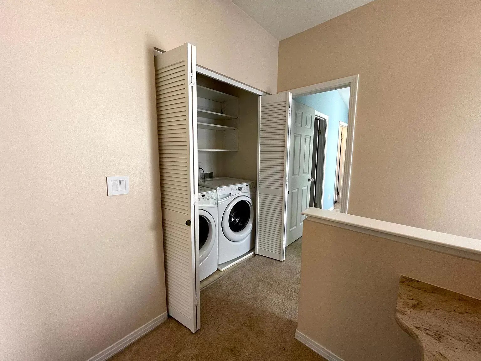 Washer and Dryer on the landing between the two bedrooms. Plenty of storage and room for folding. - 1641 N Washington St