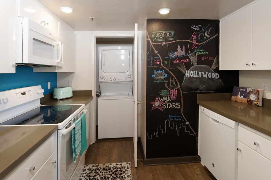 Standard Apartment Kitchen with Chalkboard Accent Wall and Washer Dryer - AVA Studio City