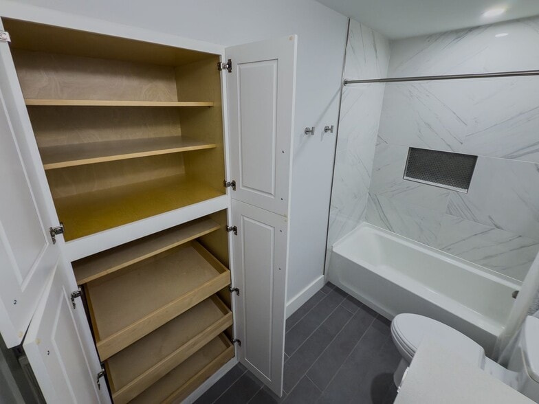 Built-in linen closet with pull-out shelving - 2006 Candle Ct