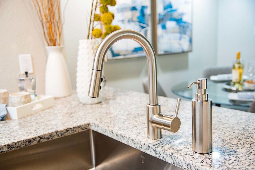 Kitchen with granite counters & stainless finishes - The Grove at Five Points