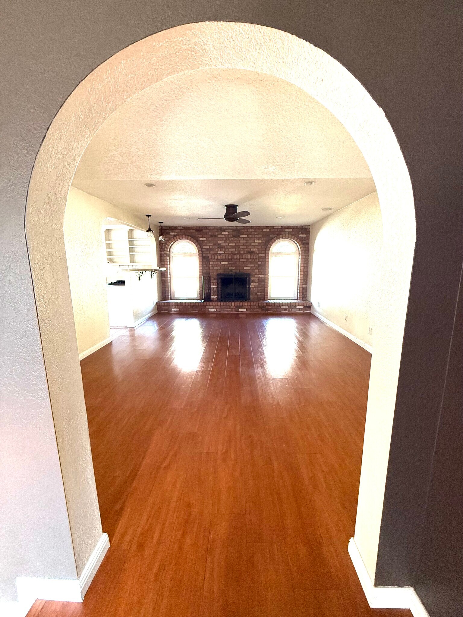 View through the arch into family room which connects to kitchen - 8315 S Taylor Dr