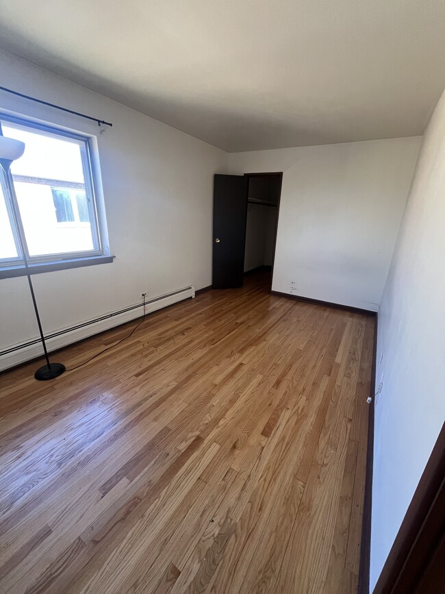 Bedroom with wood flooring - 9202 Seymour Ave