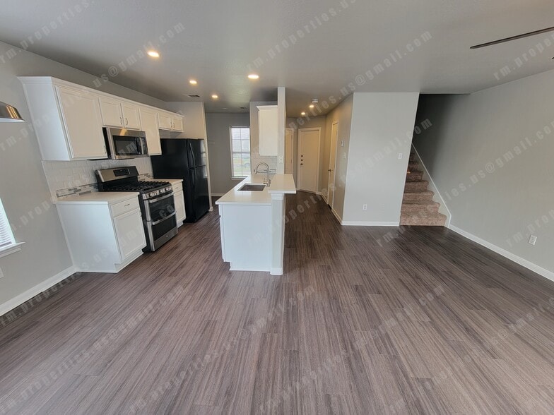 kitchen. bar top. hallway to front door, garage and bathroom. stairs to upstairs. - 2874 Southampton Way