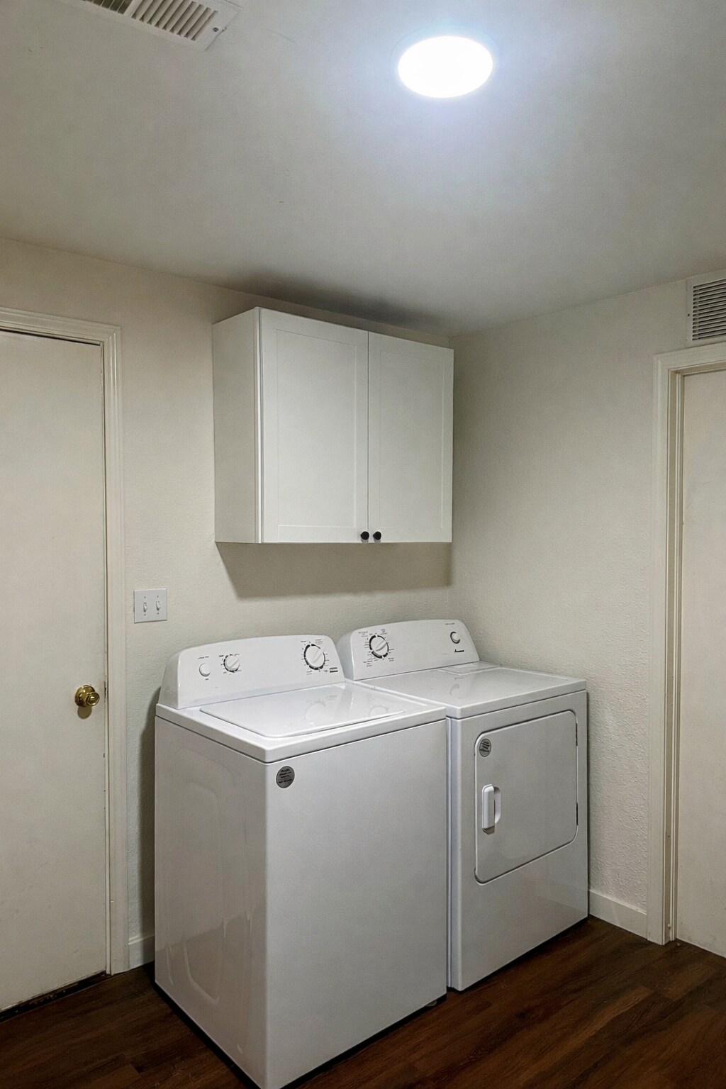 Large laundry room with newer appliances and ample storage space. - 524 Superior St
