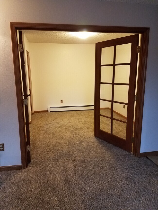 French doors to second bedroom from living room - 3031 E 42nd Ave