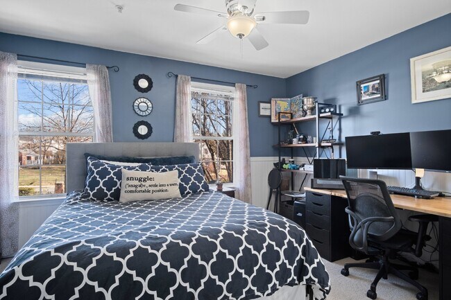 Building Photo - This inviting two-level townhome offers comfort and style, featuring gleaming hardwood floors on ...