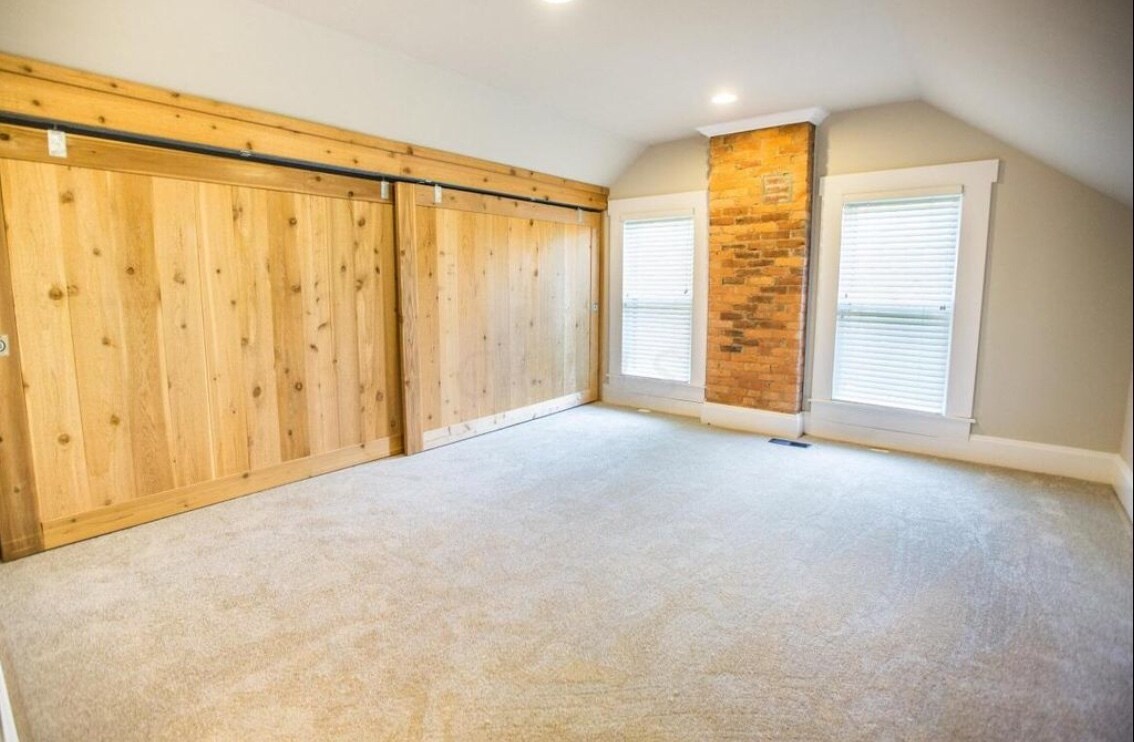 Spacious bedroom. Large closet with chic barn door feature. - 715 S 5th St