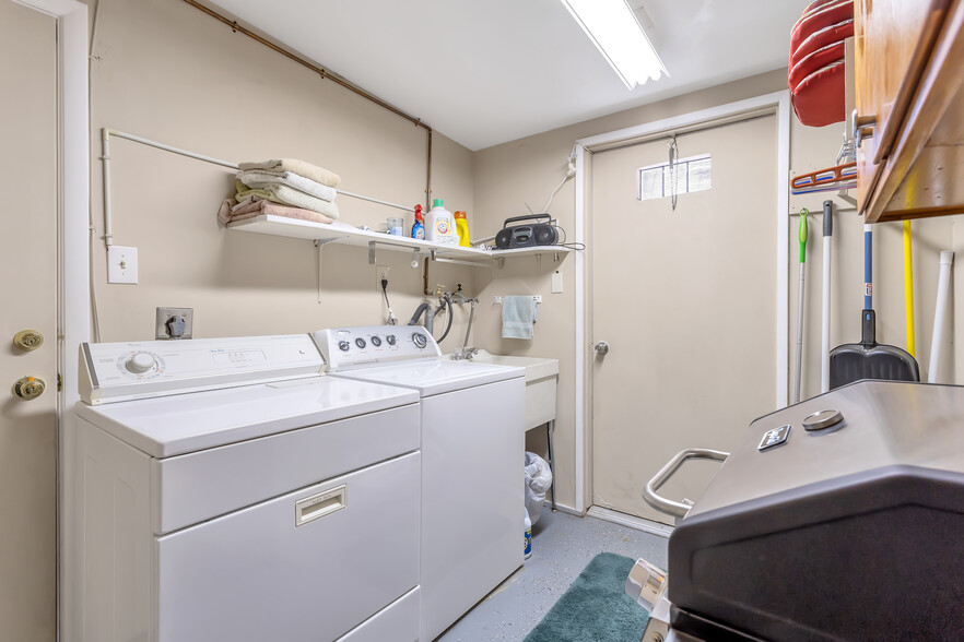 Laundry room with washer, dryer, clothes rod and extra storage. New washing machine not shown. - 10113 W Pebble Beach Dr