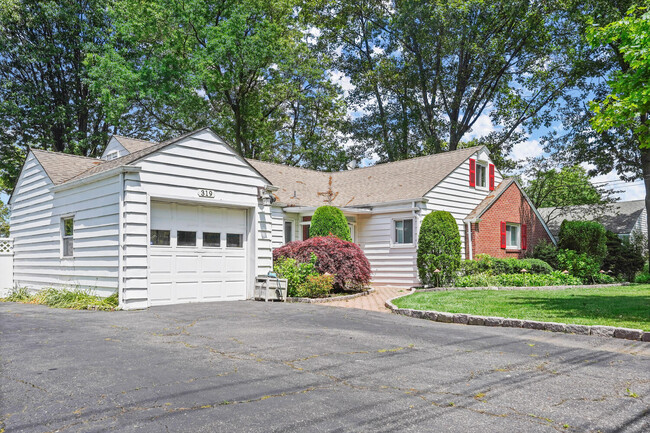 Plenty of parking in large driveway and 1 car attached garage. - 319 Davenport Ave