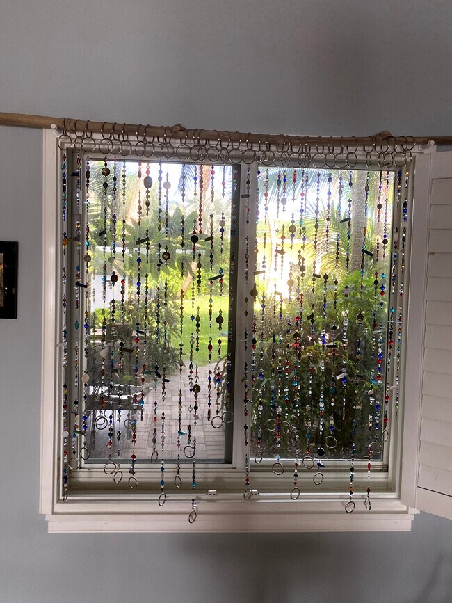 View of the lush courtyard from your workspace - 6520 N Ocean Blvd