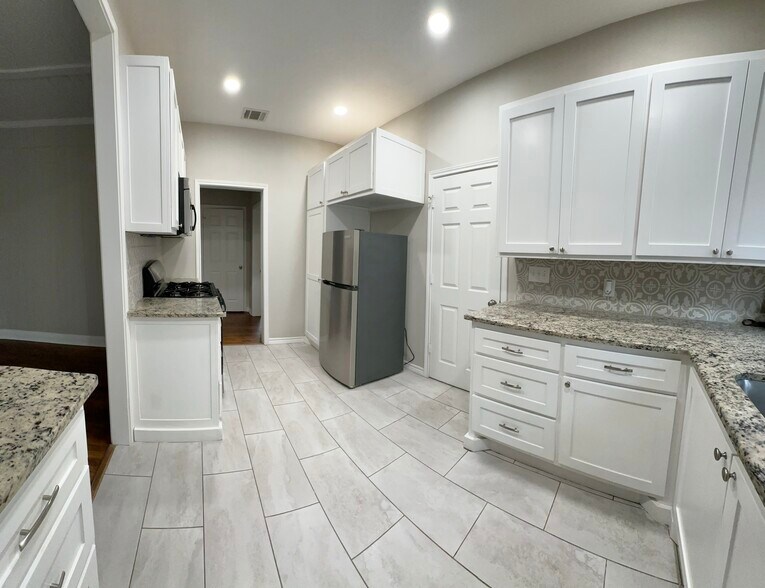 Kitchen with island and access to Laundry room - 310 2nd St