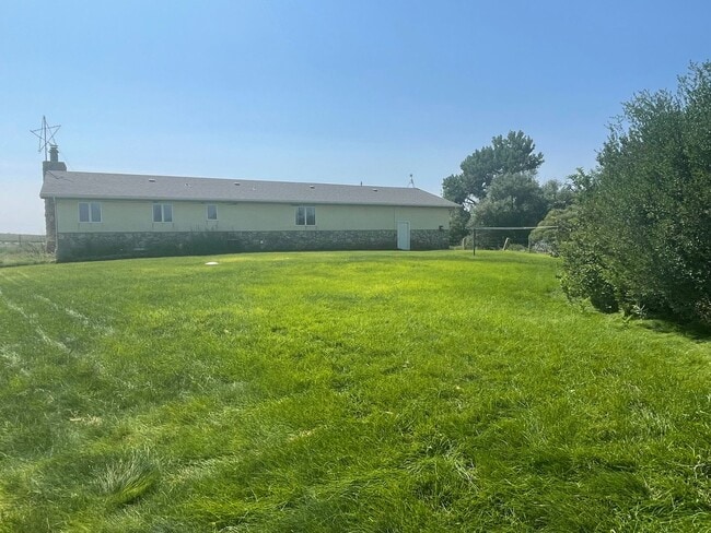 Building Photo - Spacious, four-bedroom, two-bathroom, coun...