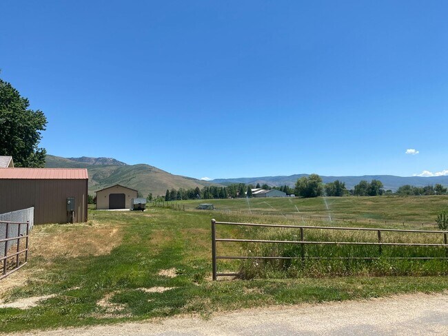 Building Photo - Beautiful home single level entry with out buildings and amazing landscaping - shorter term lease...