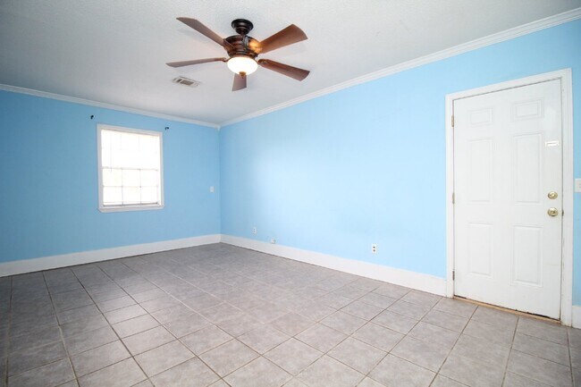 Building Photo - Spacious 3BR/1.5BA Home in Pace with Open Living Area, Tiled Family Room, and Fenced Backyard – M...