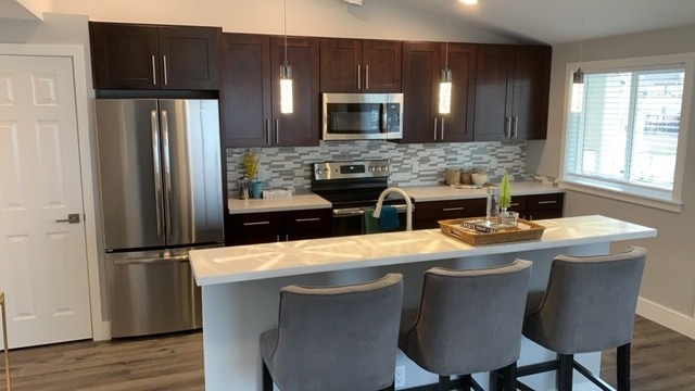 Gourmet Kitchen with Bar - Highridge Apartment Homes