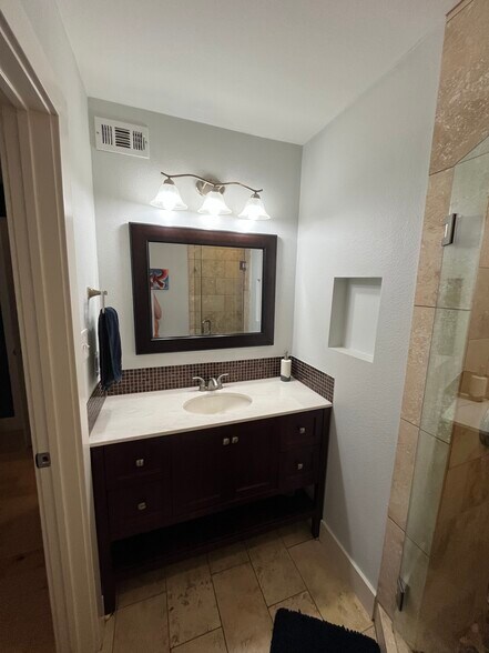 The master bedroom features an en suite bathroom. - 909 Reinli St