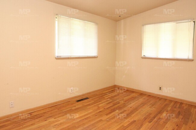 Building Photo - Three Bedroom with Covered Parking Spot!