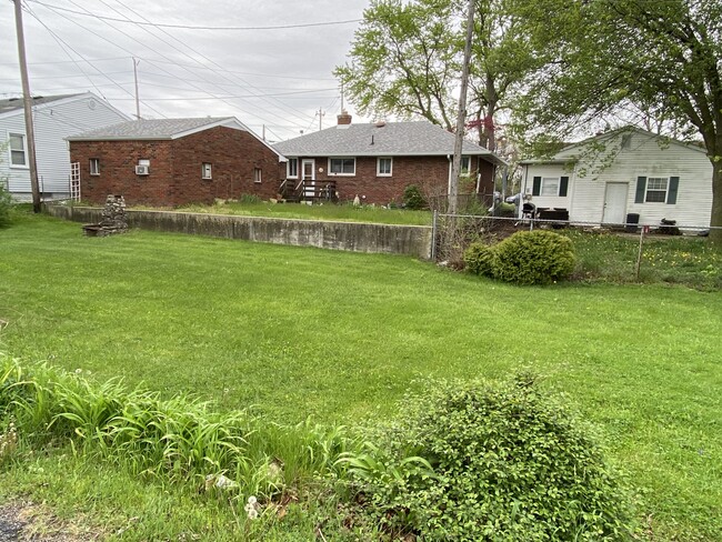 East side of yard (with stone grill) - 128 Standish Dr