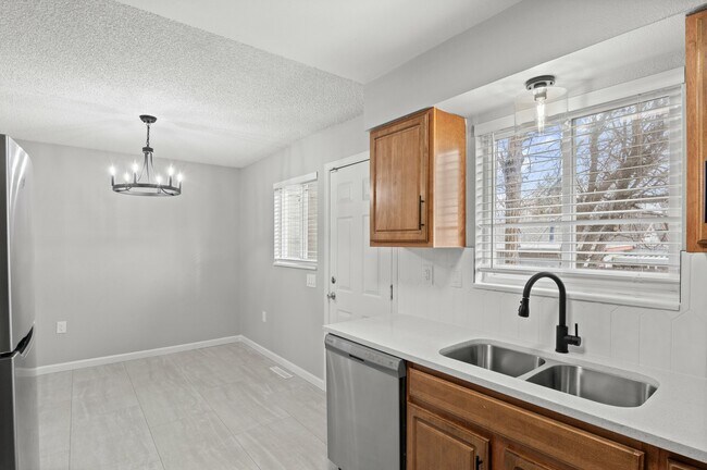 Embrace modern living with this airy kitchen, perfect for culinary enthusiasts and home gatherings. - 5580 West 4th Avenue Townhomes