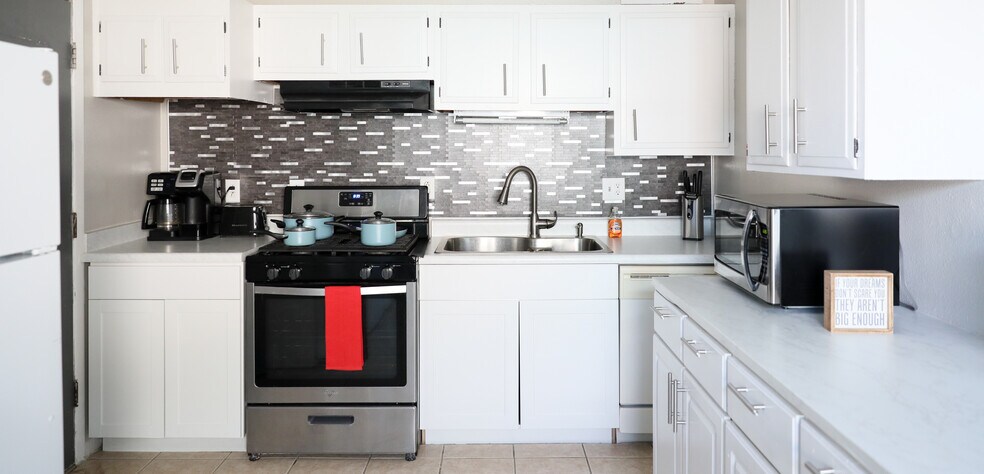 Welcome to your kitchen! It features pots, pans, lids, utensils for cooking and eating. Dishwasher - 8612 Echo St