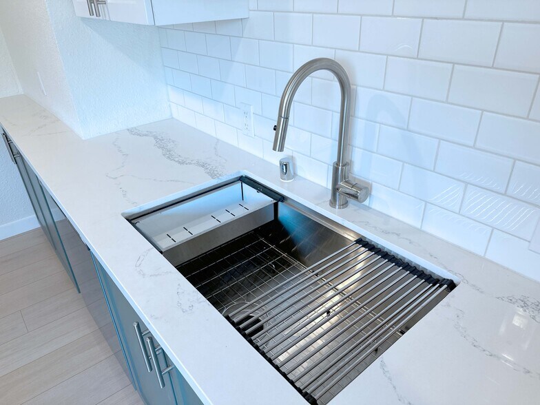Modern kitchen sink with built-in cutting board, fruit washer, and convenient dish dryer—designed fo - 4570 58th St