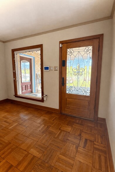 2 lead glass Fleur de Lis exterior doors - 3311 River Rd