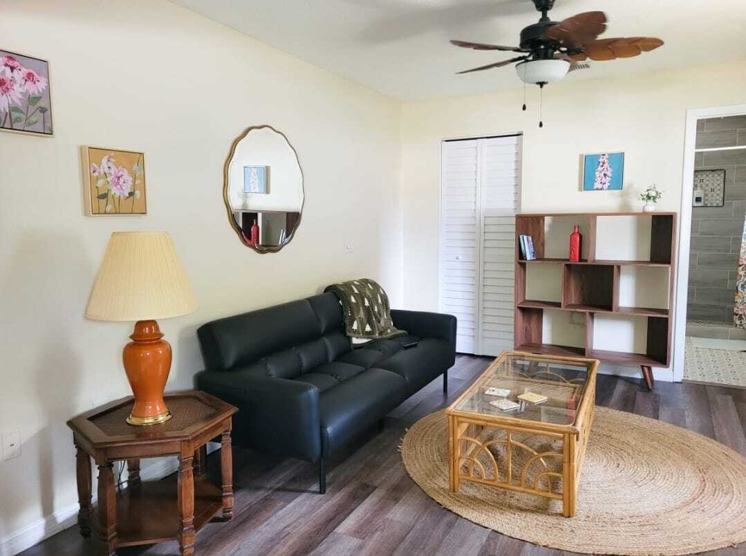 The living room features a futon, a 40" smart tv and in unit laundry - 5114 33rd St E