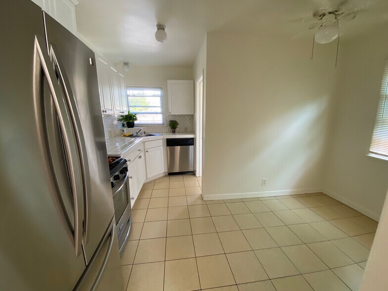 Kitchen and dining area - laundry room and back door to yard at far end on right - 935 Victoria Ave