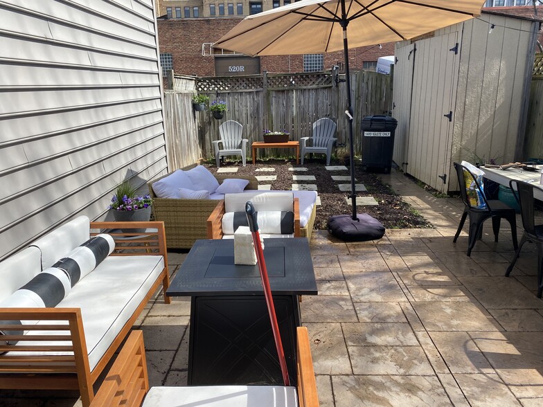 Fully fenced, private backyard with 400 sq. ft. patio, furnished with patio furniture and grill set - 519 N Payne St