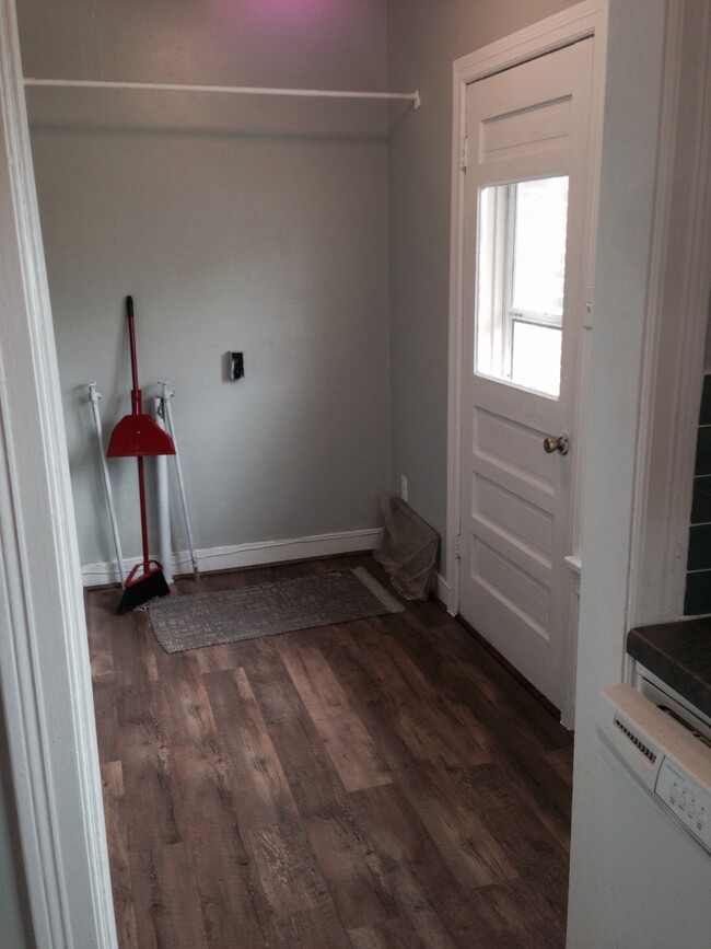 Service porch which now has washer/dryer combo and side entrance to privacy fenced yard. - 4104 Dover St