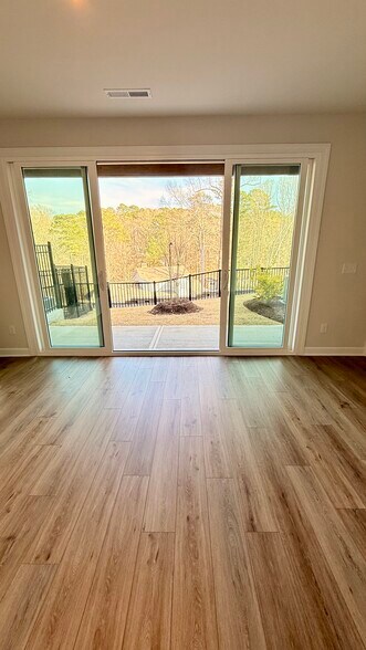 Finished lower-level flex space with full bathroom and walk-out patio access. - 4720 Cypress Tree Ln