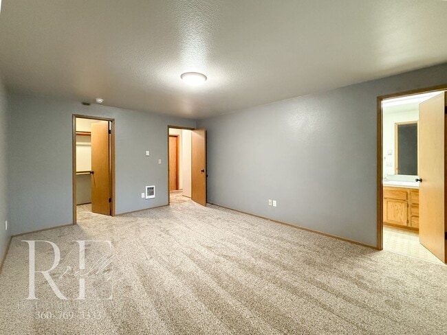 Building Photo - Vaulted Ceilings, Skylights & a True Primary Suite in This Gig Harbor Duplex