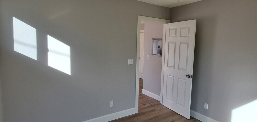 bedroom, looking towards living space and kitchen - 7650 Ostrom Ave
