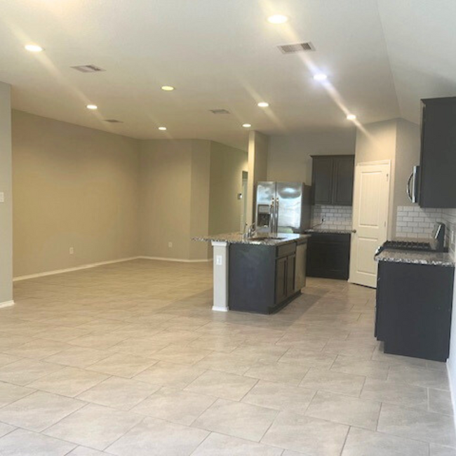 View of the kitchen from back door - 8310 Rose Petals Ln