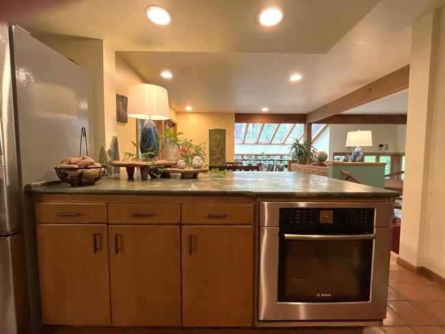 Building Photo - One-of-a-Kind Custom Home with Wall of Windows, Stone Fireplaces, Expansive Entertainment Space &...