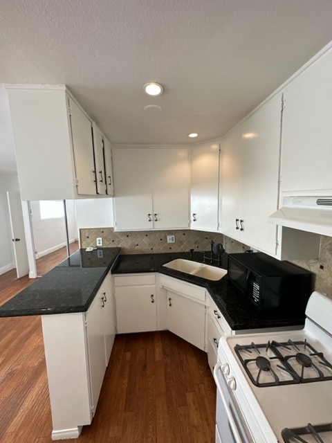 Beautiful black granite, top and tiled backsplash give the unit a touch of elegance! - 5545 1/2 Allott Ave