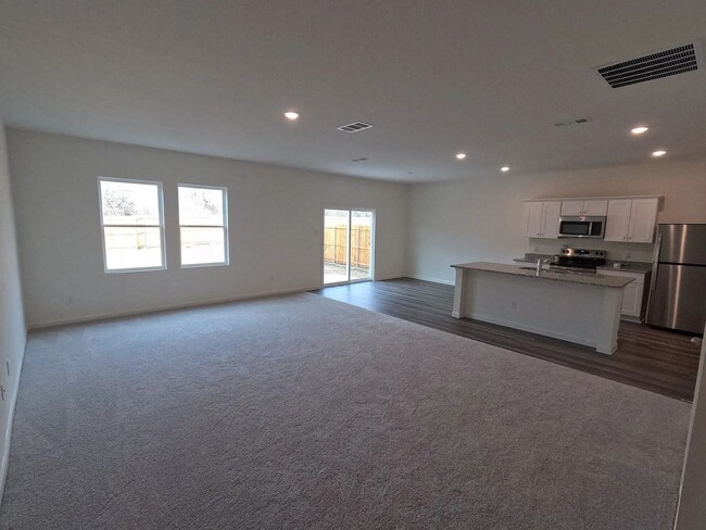 Building Photo - This home features four spacious bedrooms,...