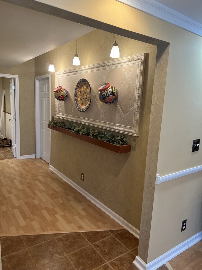 Hallway from kitchen and living room leading to bedrooms and laundry room. - 3617 Sunset Rdg