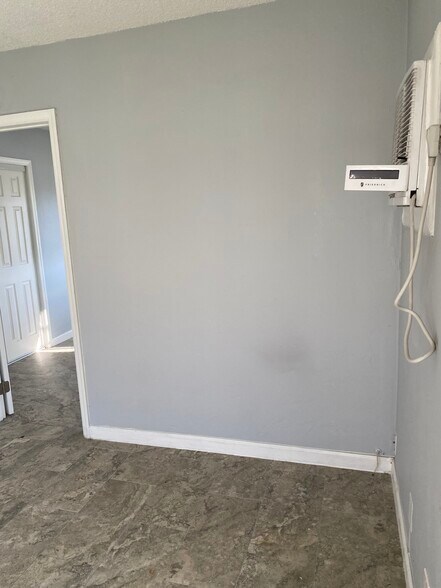 Entranceway from living room to bedroomview of West Apartment with tenant’s planters - 3049 NE 20th Ter