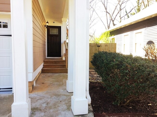The craftsman-style front door with sidewalk and patio stones leading to the fenced back yard - 190 Hutchinson St NE