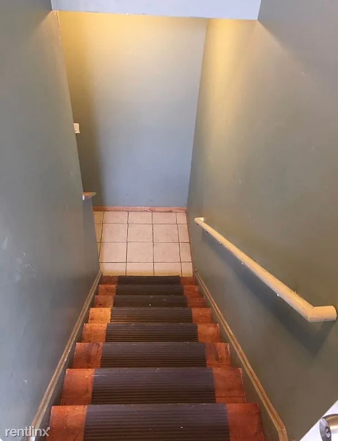 Stairs to downstairs level. - 419 W Root St
