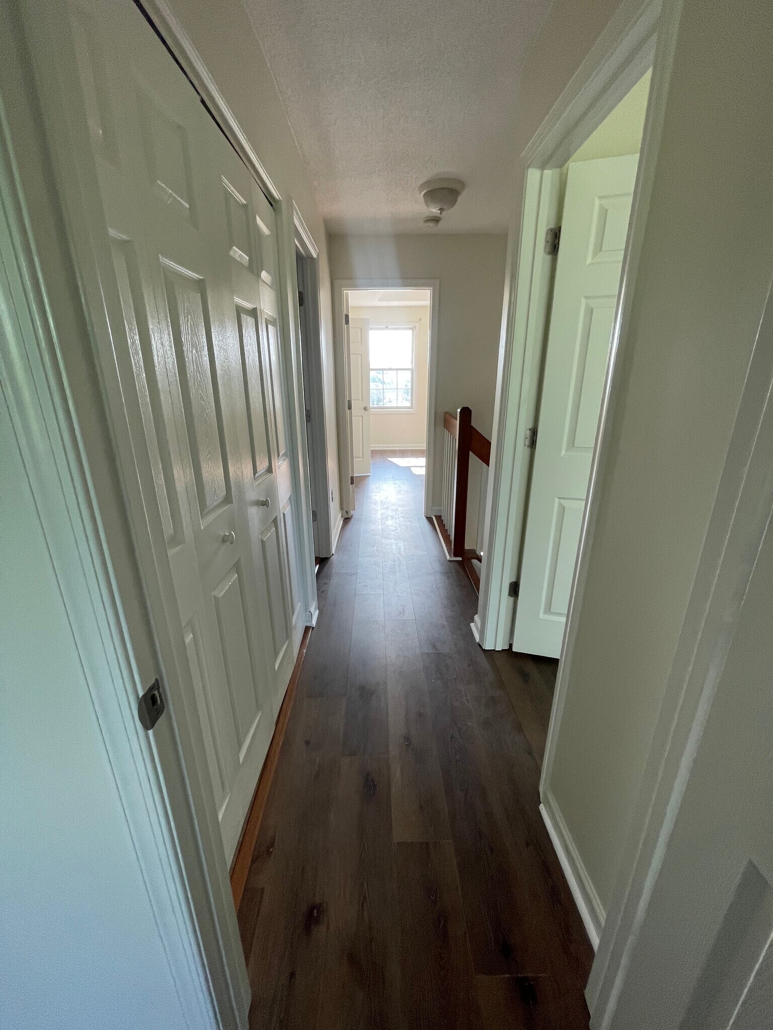 Upstairs hall with laundry, full bath looking into master bedroom - 1419 Founders Way
